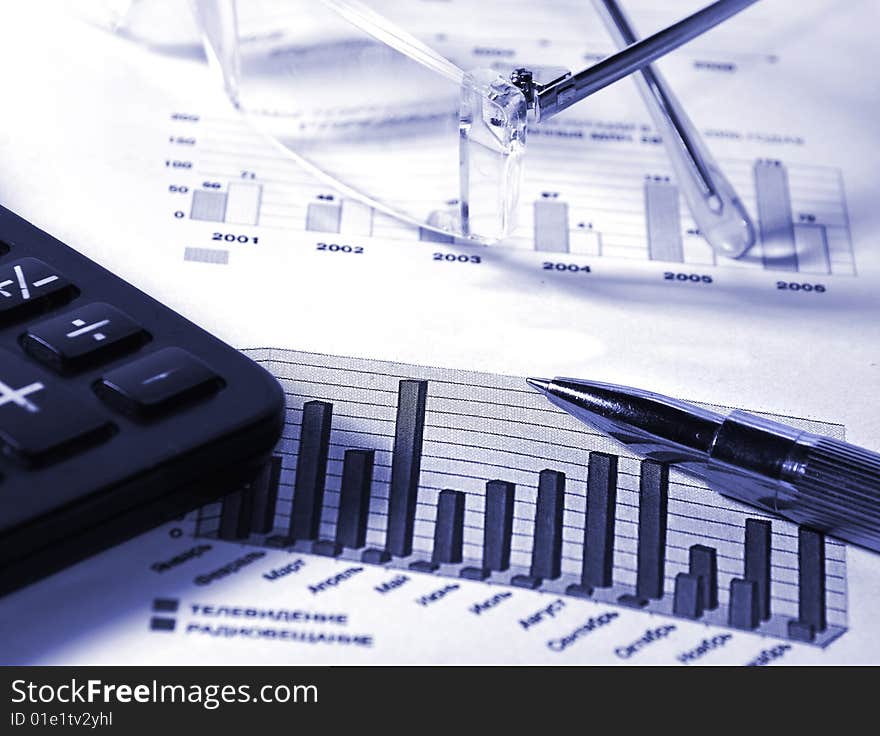 Calculator, fountain pen, glasses and stock chart. Calculator, fountain pen, glasses and stock chart