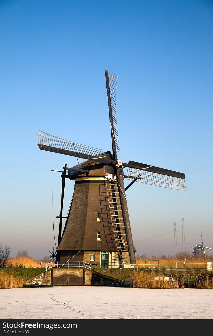 Dutch windmill with ice on the water