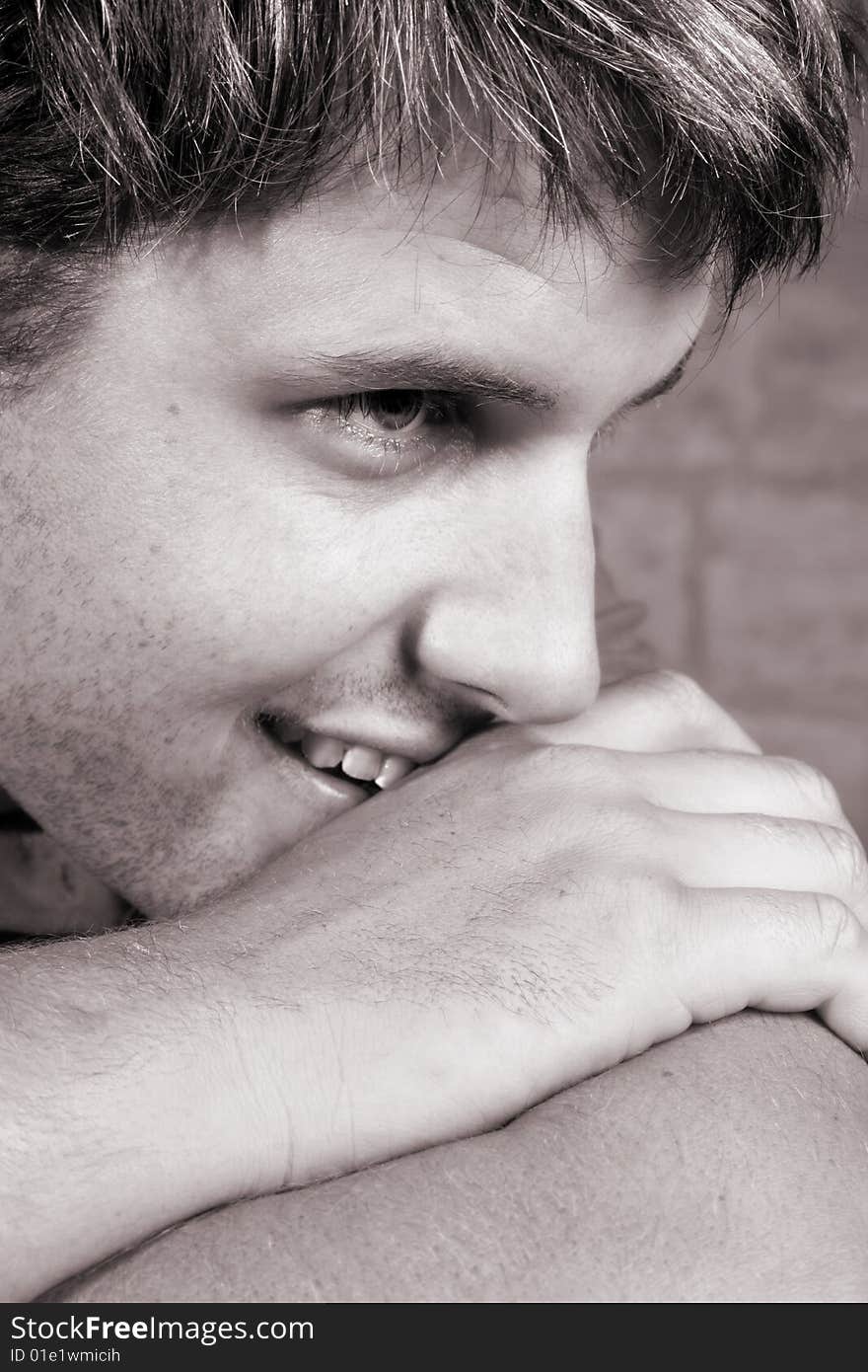 Male model against a rough brick wall background