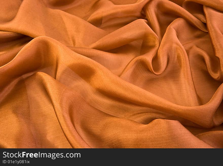 Folds on brown aglint silk