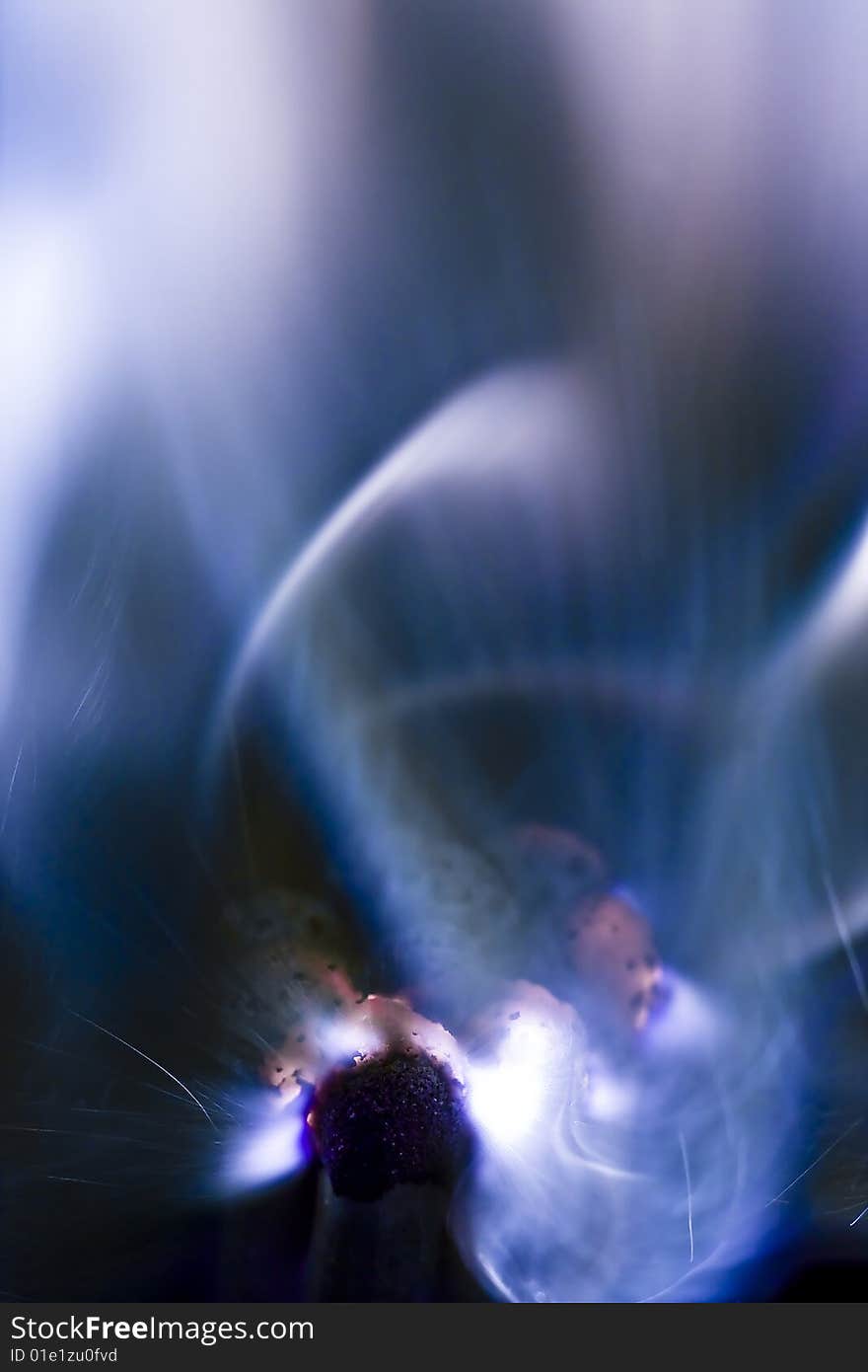 Photo of a burning match in a smoke on a black background. Photo of a burning match in a smoke on a black background