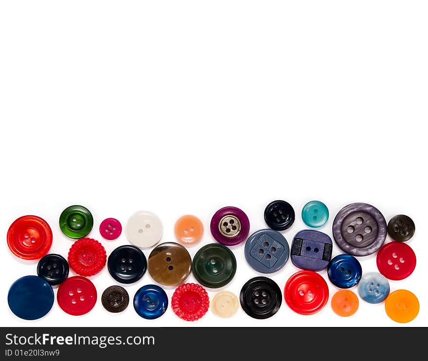 Colored sewing buttons in a line on a white background. Colored sewing buttons in a line on a white background