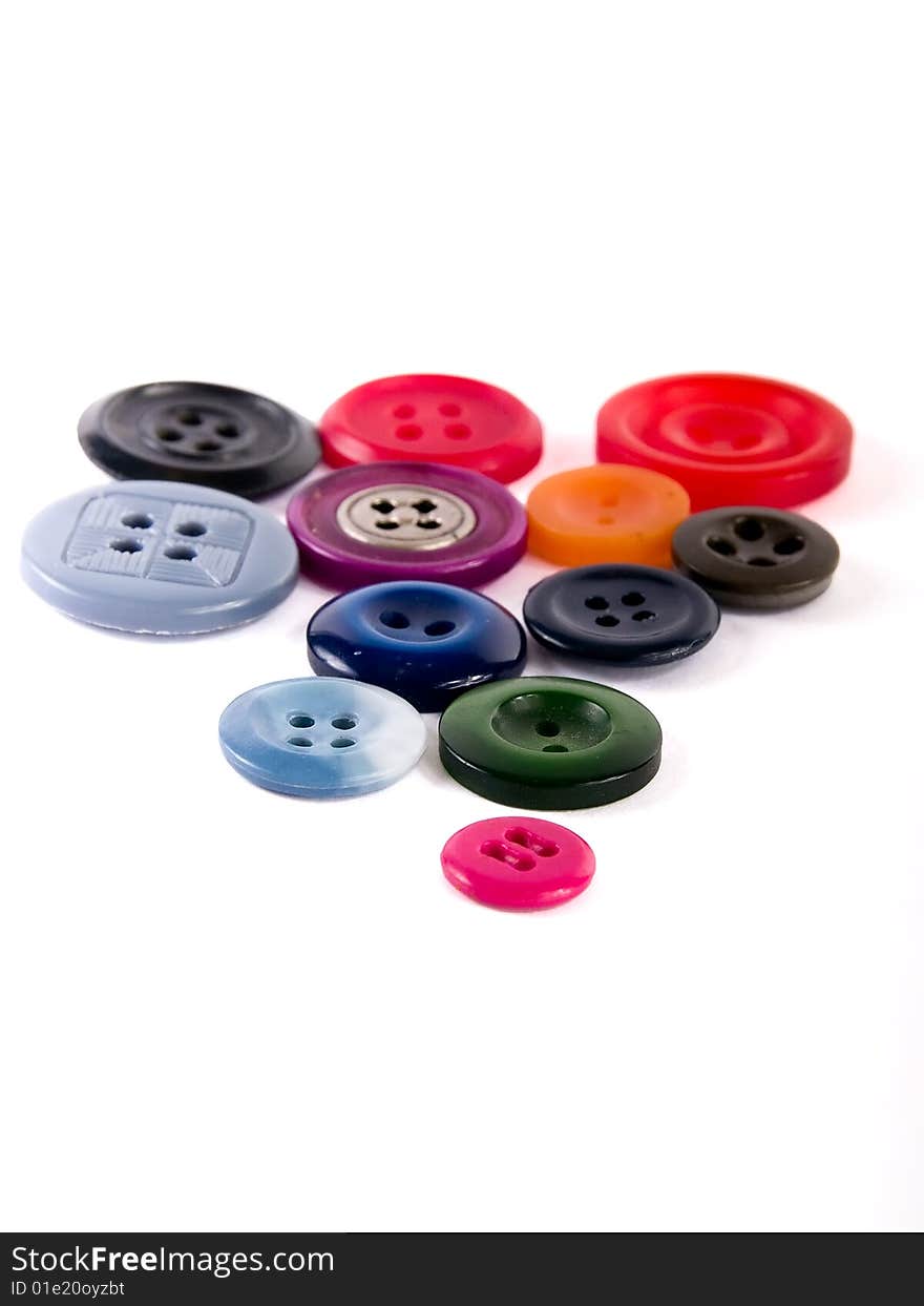 Colored sewing buttons on a white background