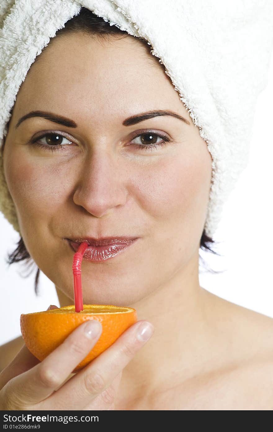 Beautiful young woman with towel on head and orange