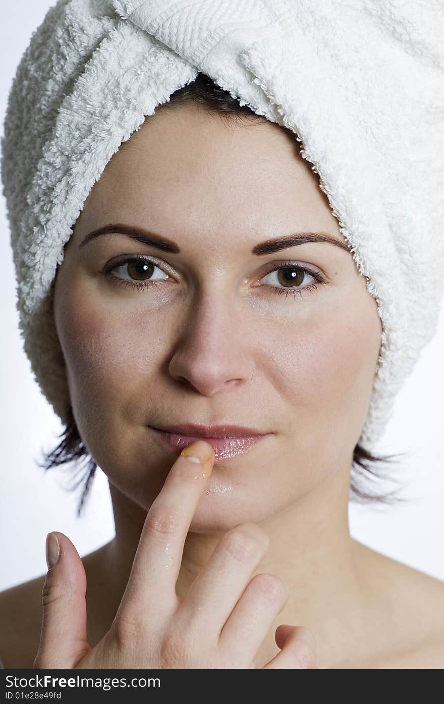 Beautiful young woman with towel on head and honey