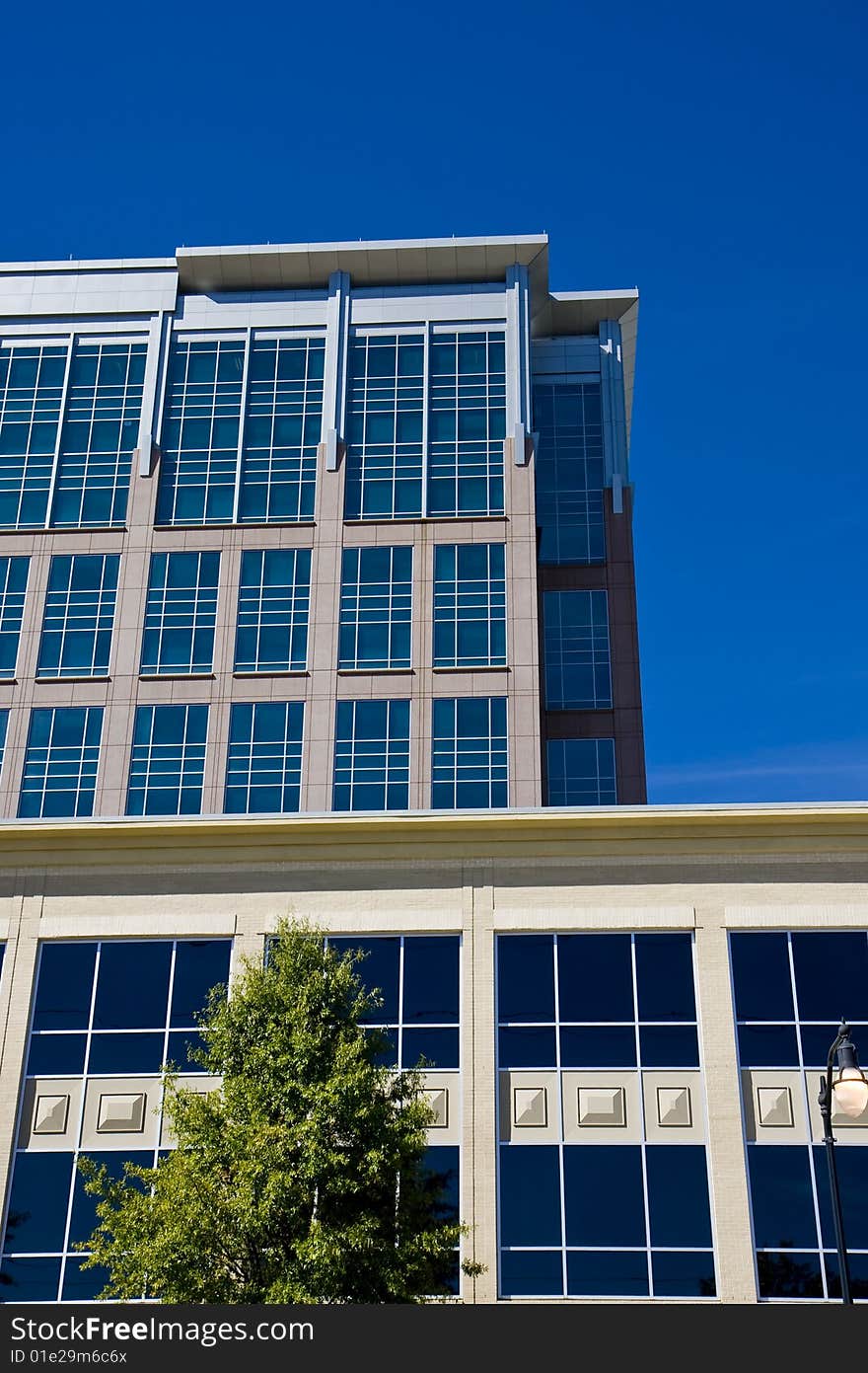 Two office buildings rising against a blue sky. Two office buildings rising against a blue sky