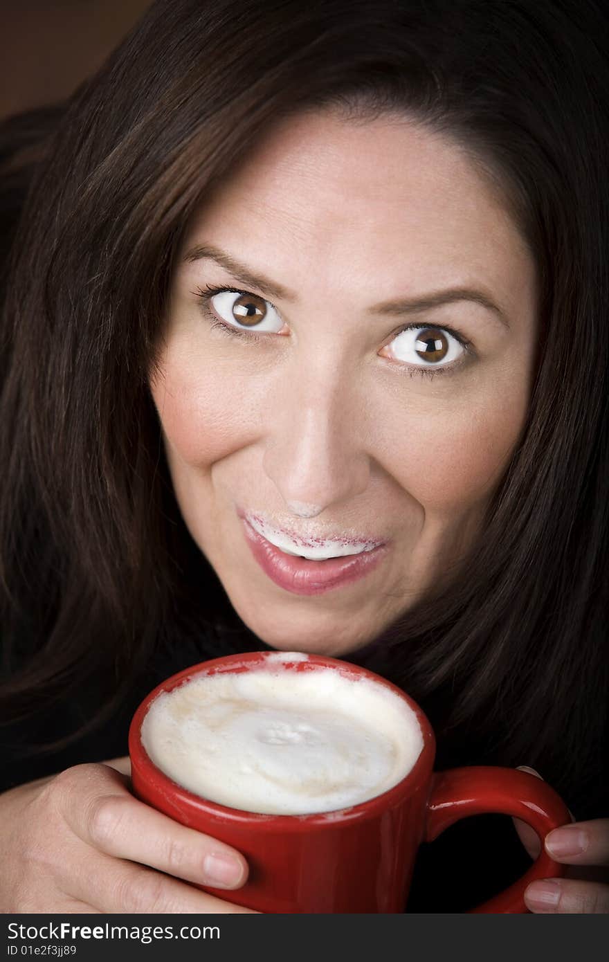 Woman with foam from coffee specialty drink on her lip and nose. Woman with foam from coffee specialty drink on her lip and nose