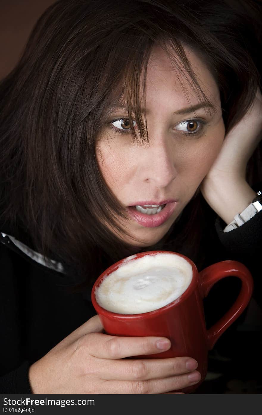 Half awake woman cradling a mug of coffee. Half awake woman cradling a mug of coffee