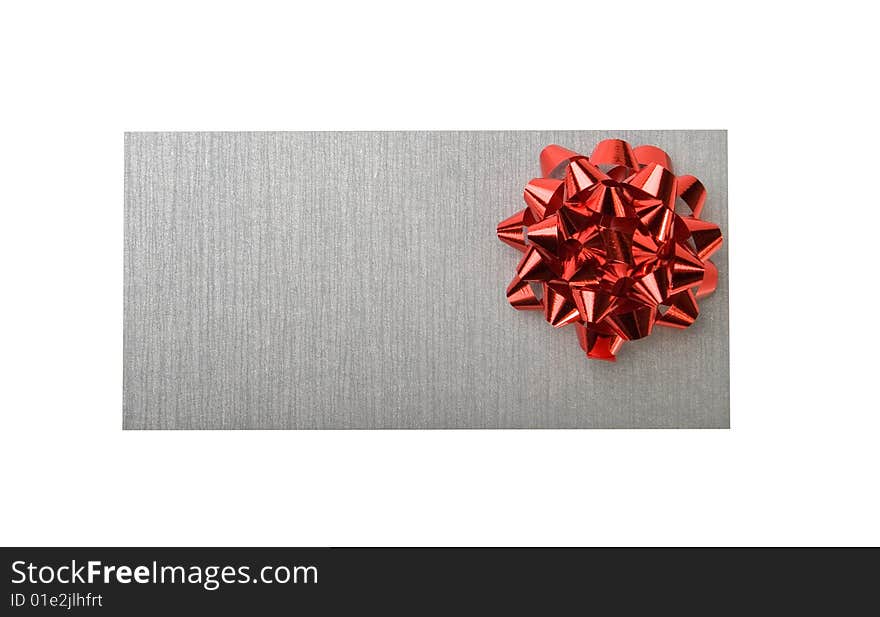 Silvery envelope with decoration red bow on white background