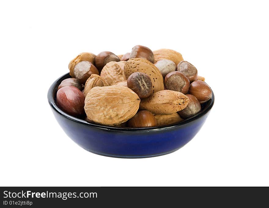 Nuts mix in blue plate on white background