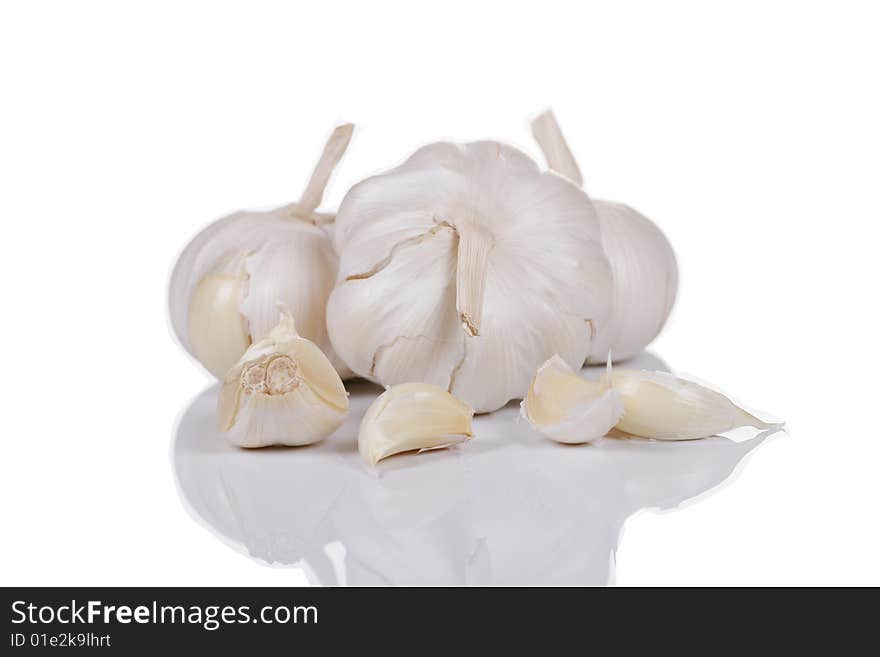 Bunch of whole garlic isolated on white with soft reflection