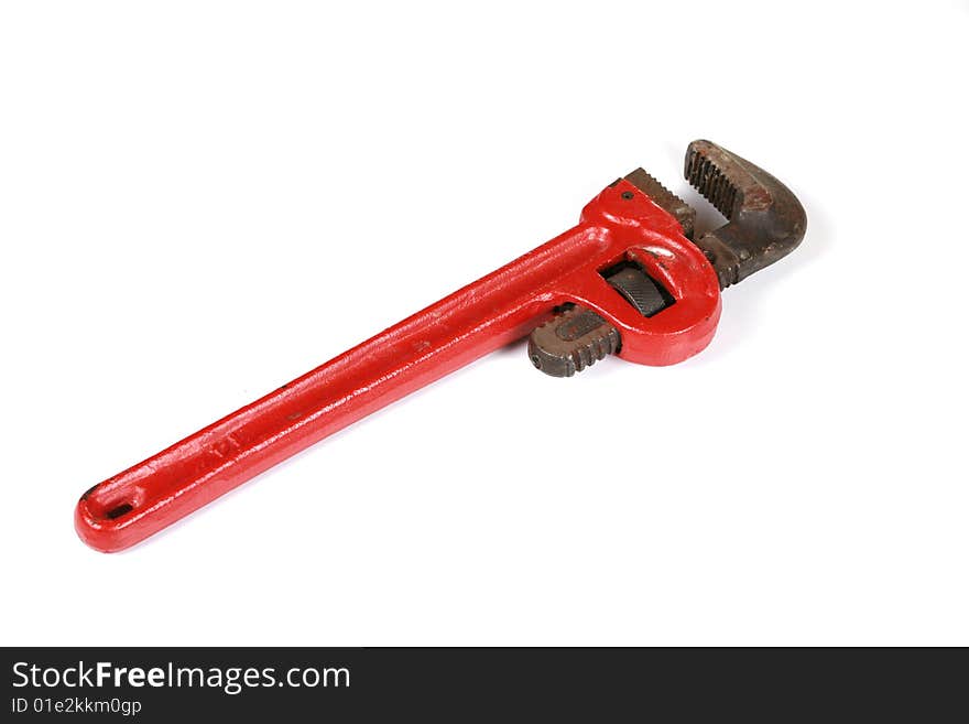 Red pipe wrench isolated on white