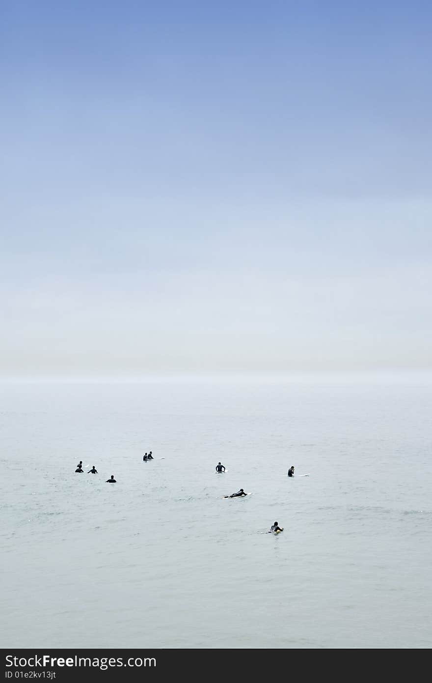 Calm ocean surfers waiting for a great wave. Calm ocean surfers waiting for a great wave