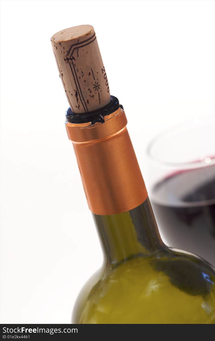 A closeup of a wine bottle and glass of red wine