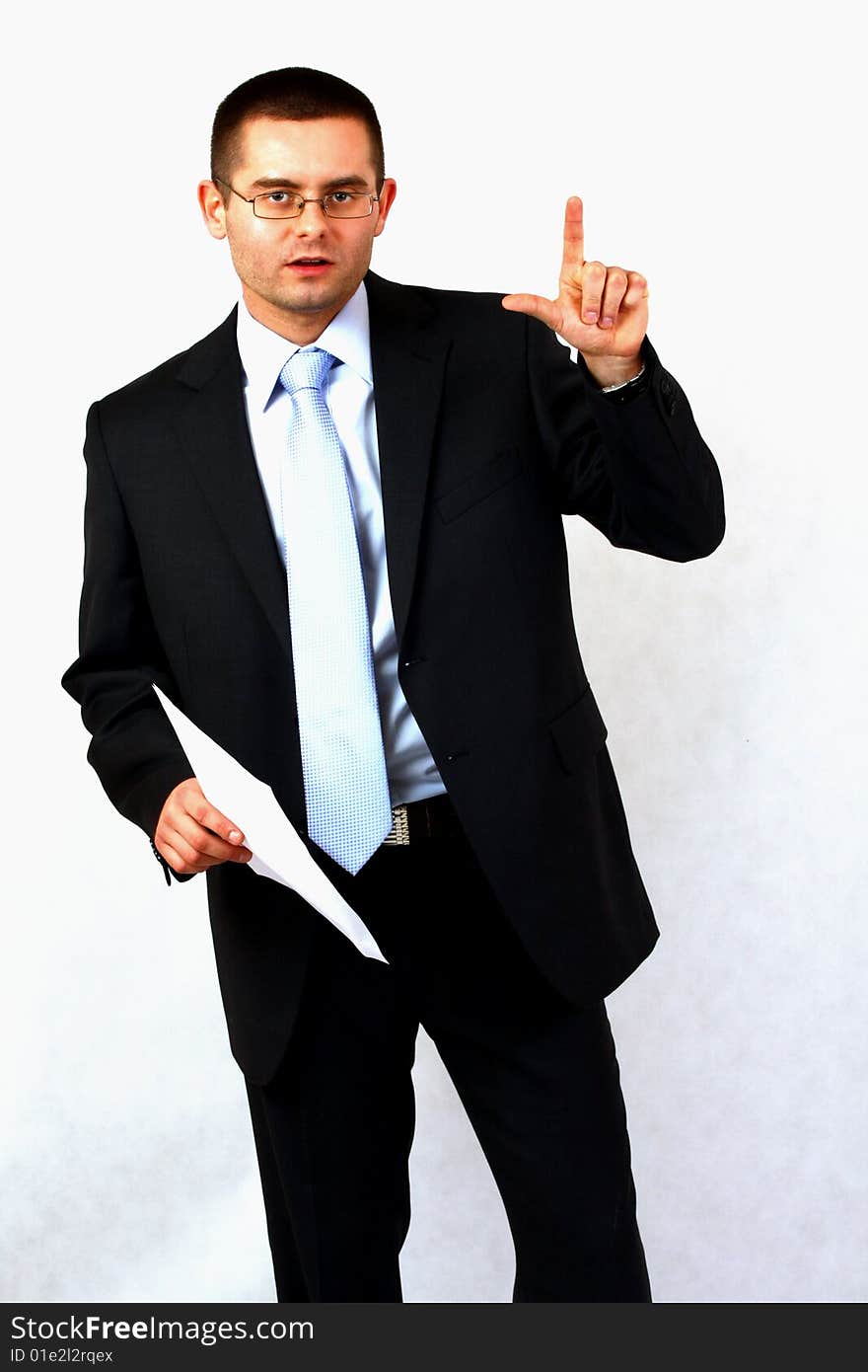 Young businessman on isolated background pointing with his finger