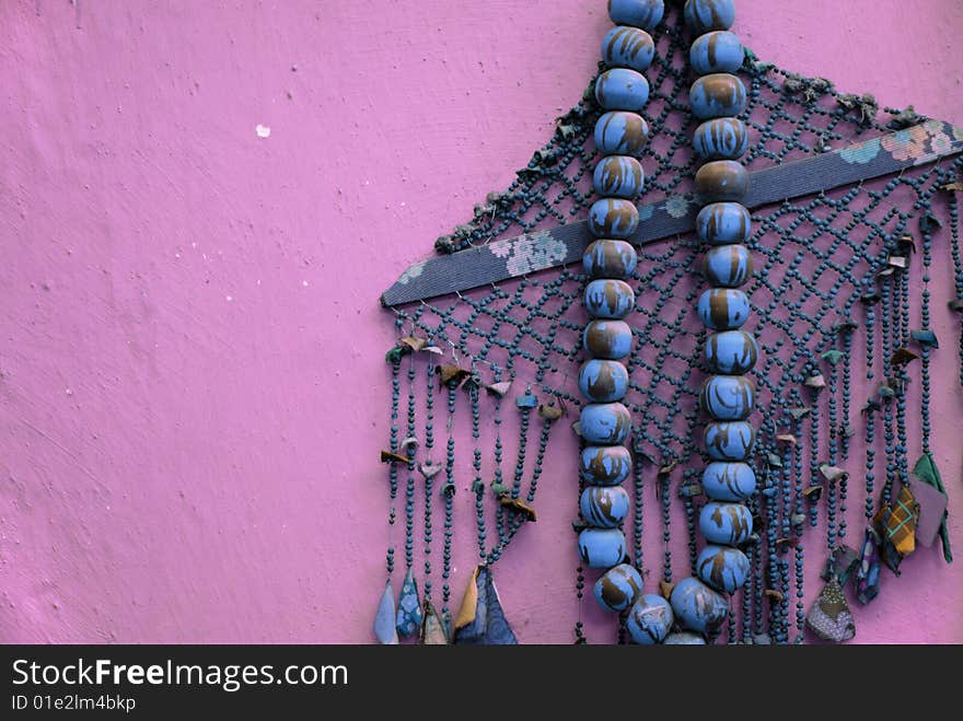 Big old rosary on pink background