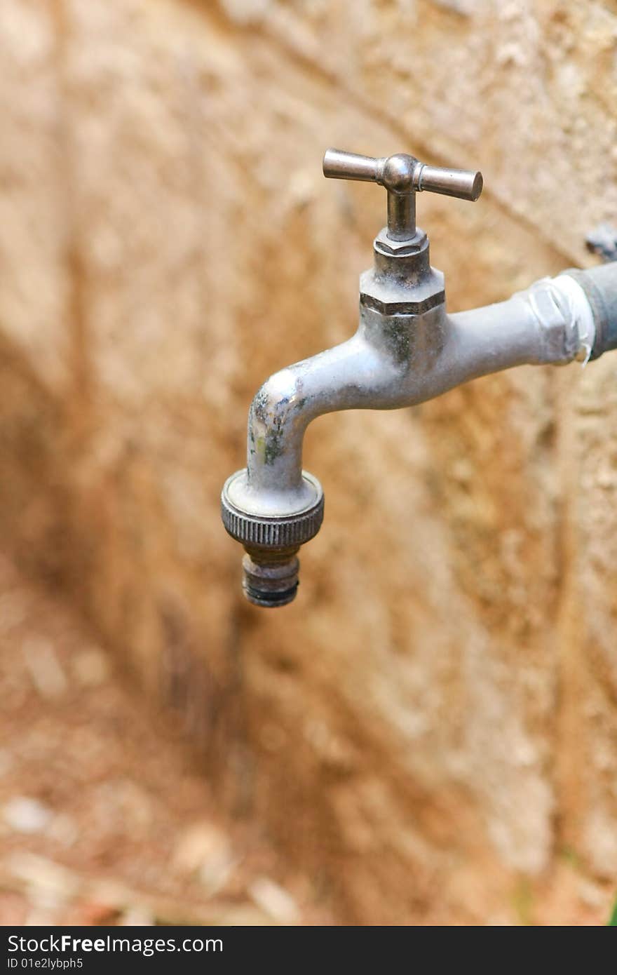 A water tap against a wall