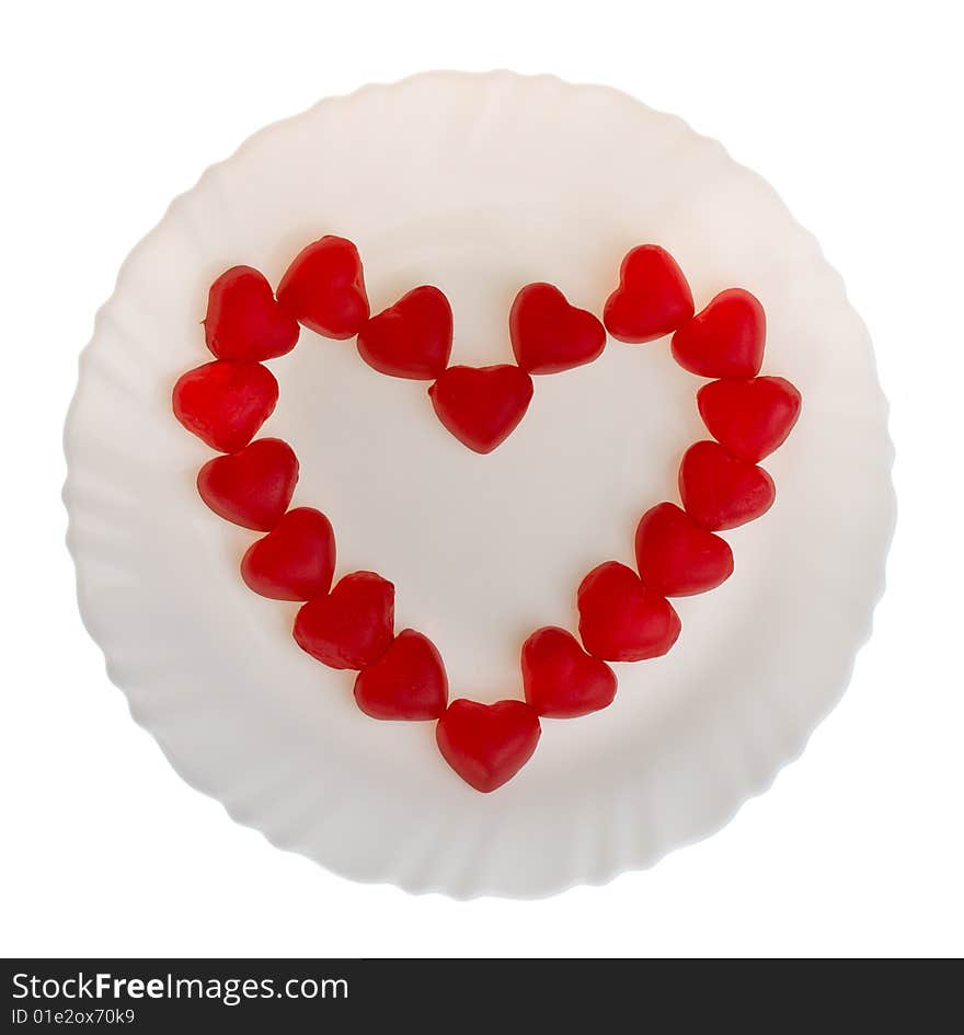 Heart shaped fruit jellies on plate, isolated on white