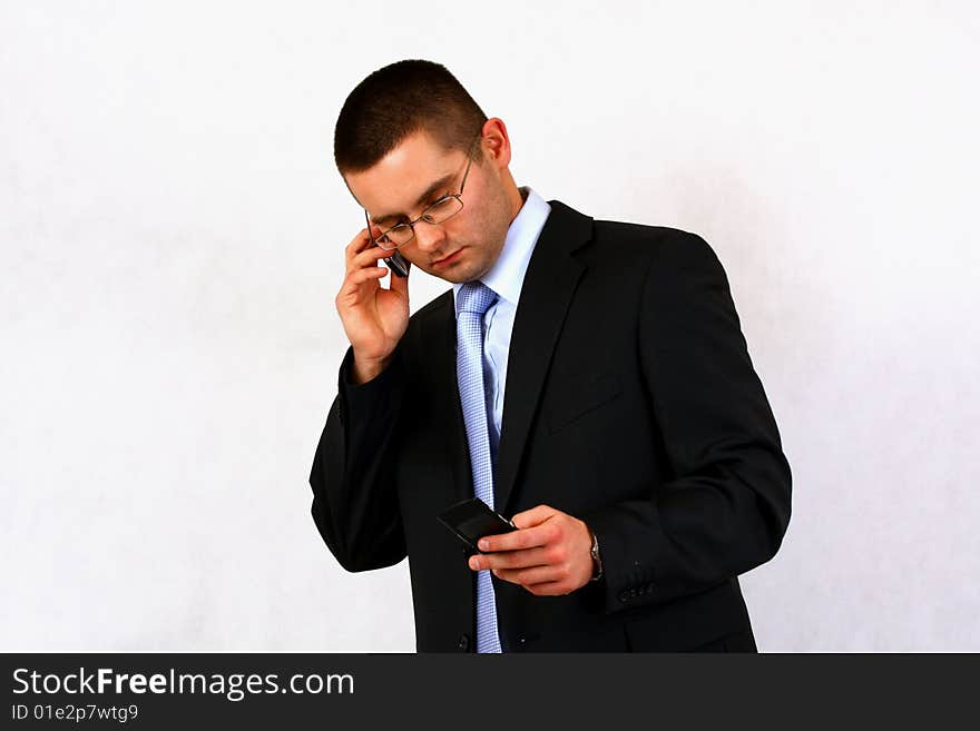 Young businessman on isolated background with a cell phone. Young businessman on isolated background with a cell phone