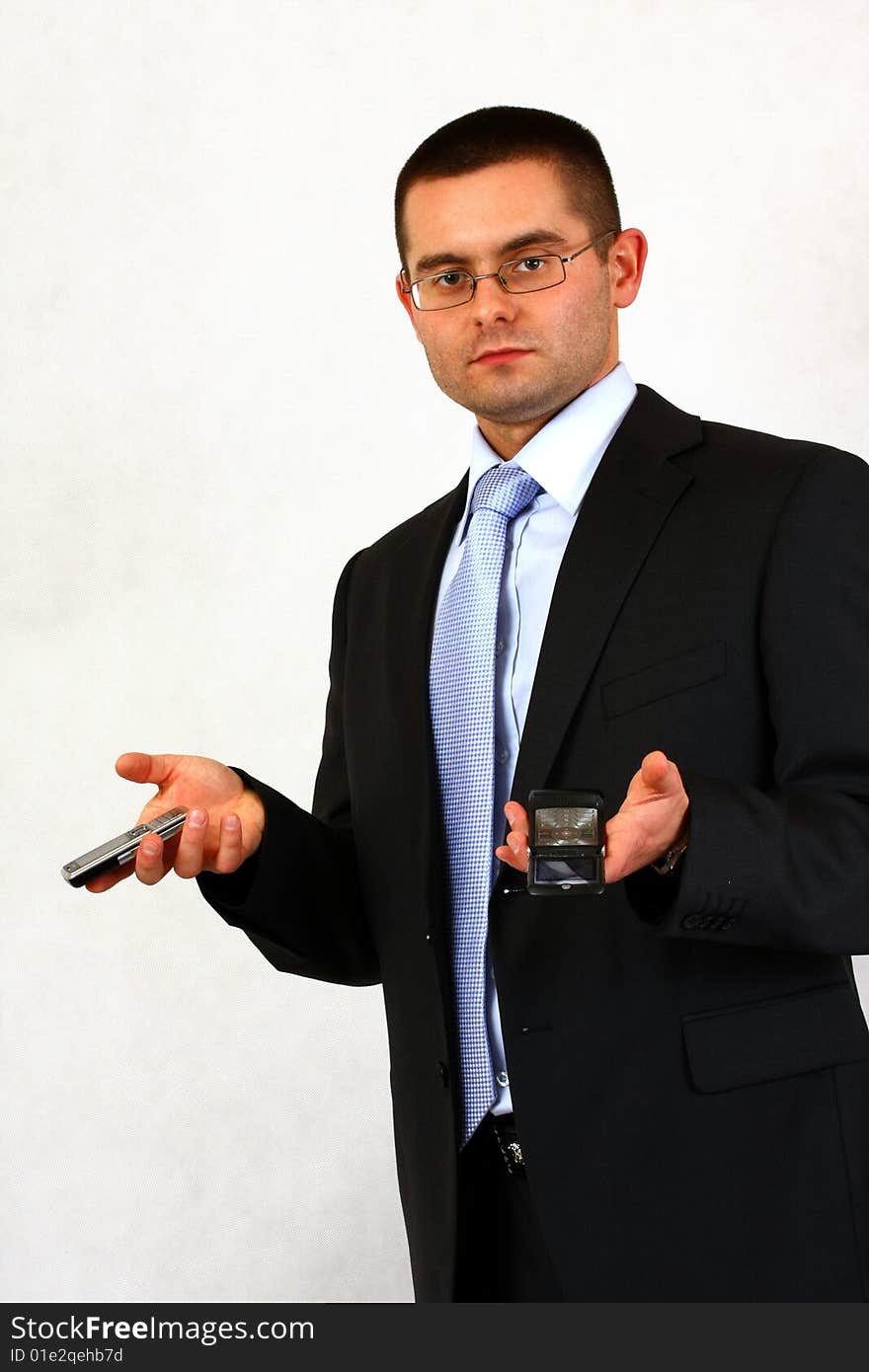 Young businessman on isolated background with a cell phones. Young businessman on isolated background with a cell phones