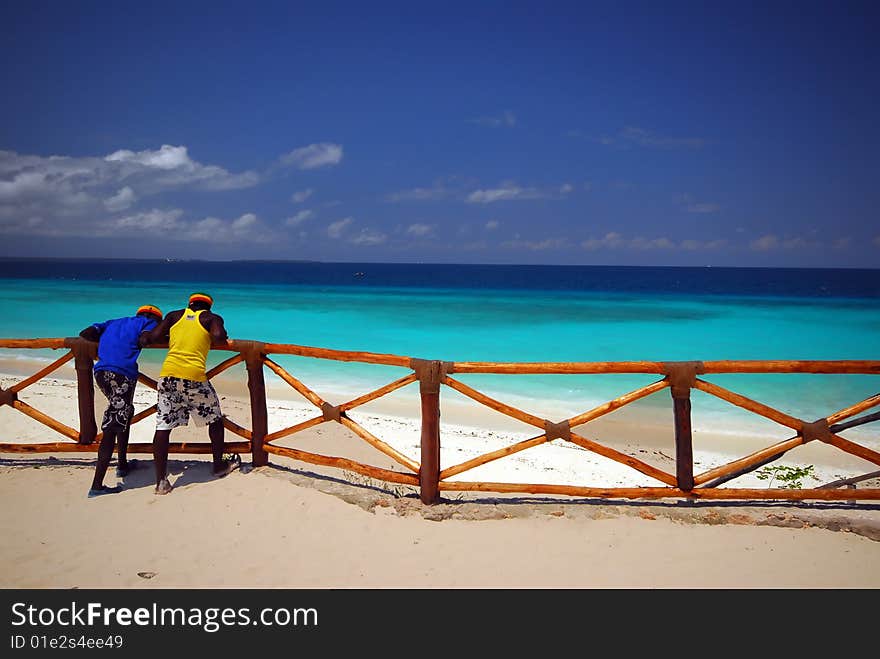 leaning on a wooden fence at the beach, zanzibar africa. leaning on a wooden fence at the beach, zanzibar africa