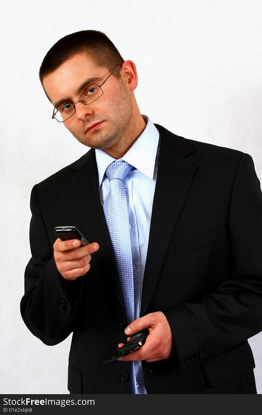 Young businessman on isolated background with a cell phones. Young businessman on isolated background with a cell phones