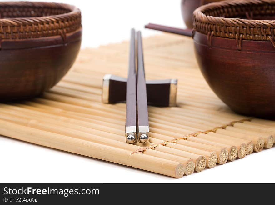 Wood empty bowl and chopsticks on bamboo mat. Wood empty bowl and chopsticks on bamboo mat