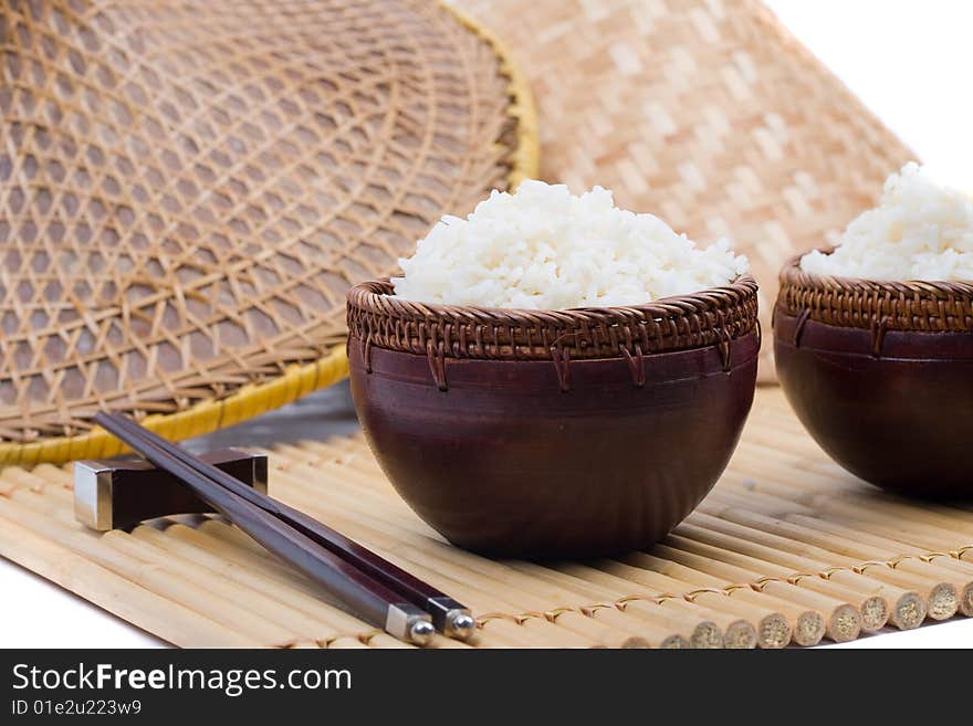 Wood rice bowl and chopsticks on bamboo mat. Wood rice bowl and chopsticks on bamboo mat