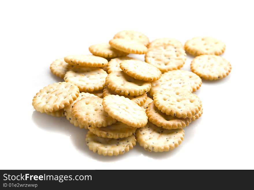 Yellow salty crackers on white ground