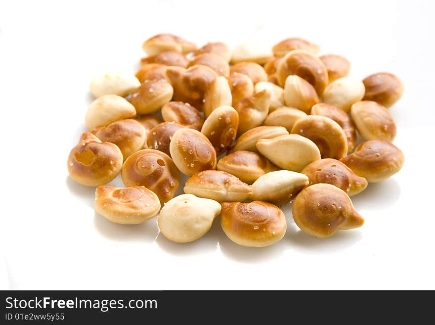 Yellow salty crackers on white ground