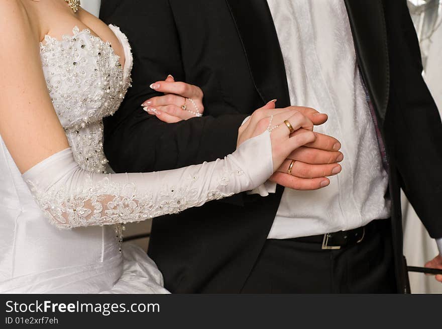 Hands of a newly-married couple.