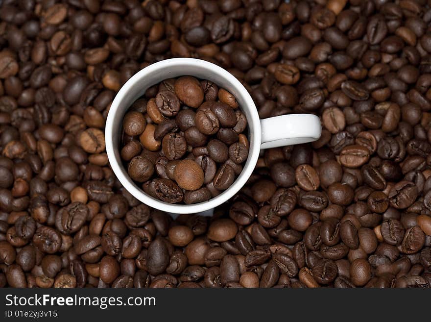 Background with white cup and coffee beans - landscape orientation