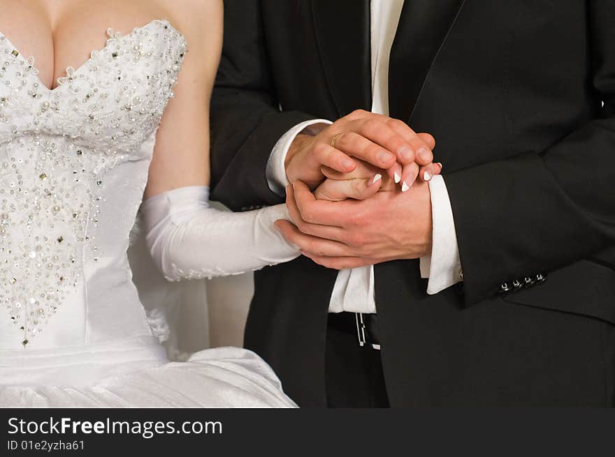 Hand of the bride in hands of the groom.