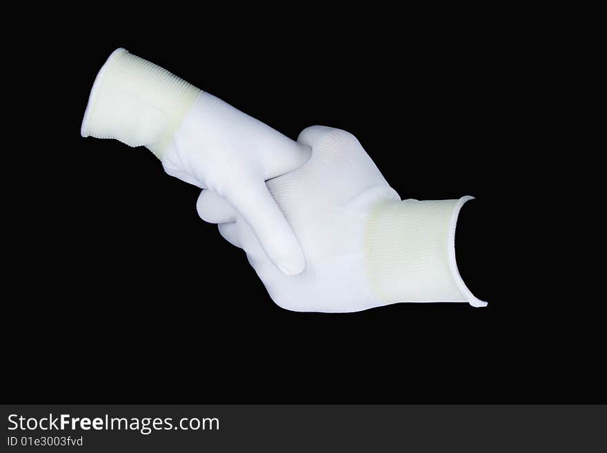 Hands in white gloves isolated on a black background. Hand shake