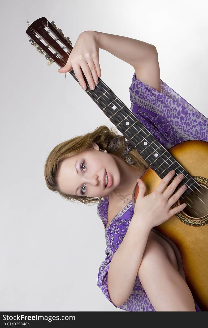 Image of a beautiful girl who plays the guitar