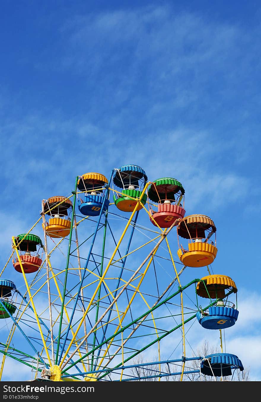 Booths of a ferris wheel in the winter empty, not a season