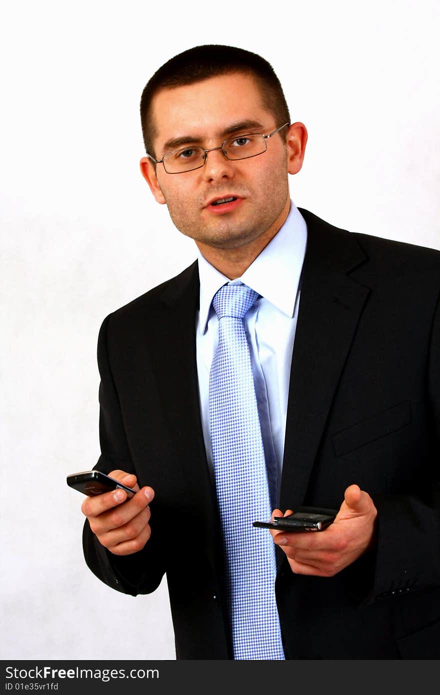 Young businessman on isolated background with a cell phones. Young businessman on isolated background with a cell phones