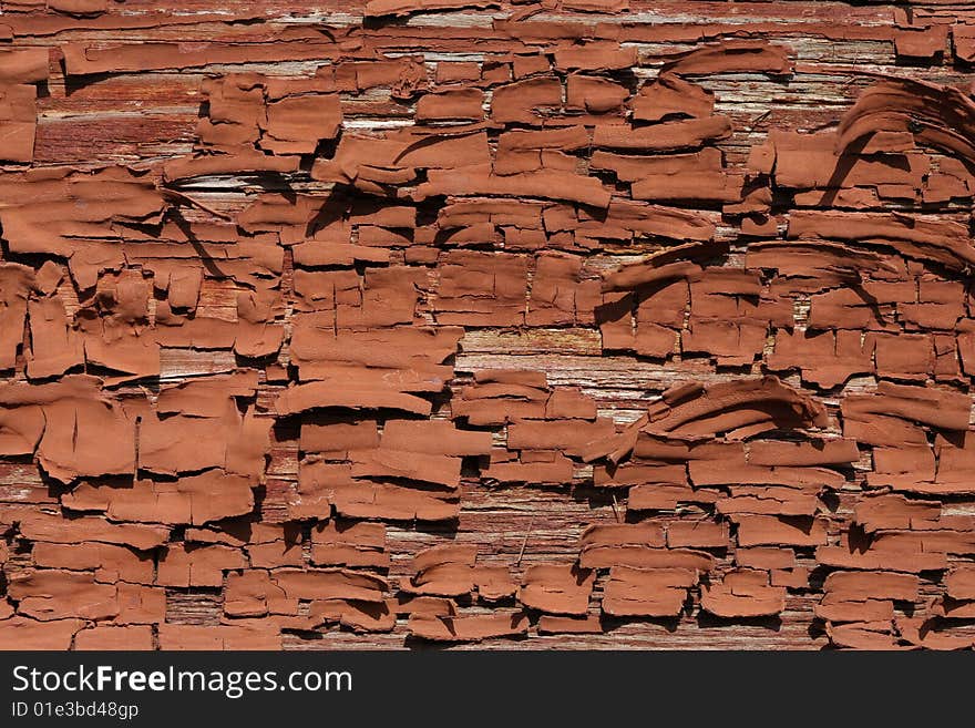 Old brown oil paint, peeling off a wooden wall. Old brown oil paint, peeling off a wooden wall