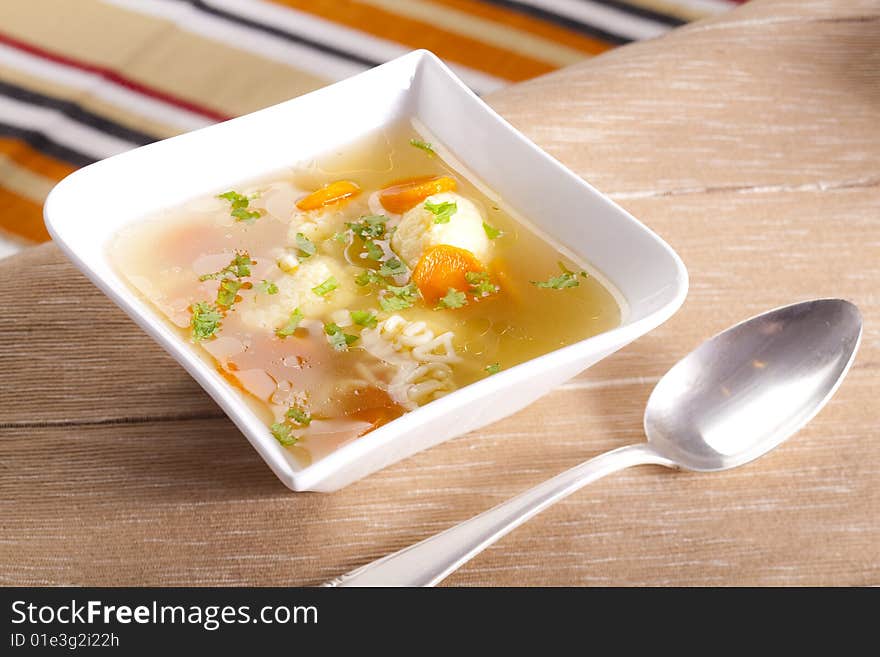 Noodle soup with dumplings and carrots