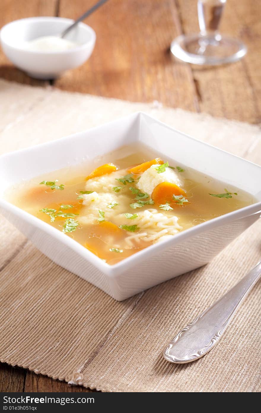 Noodle soup with dumplings and carrots