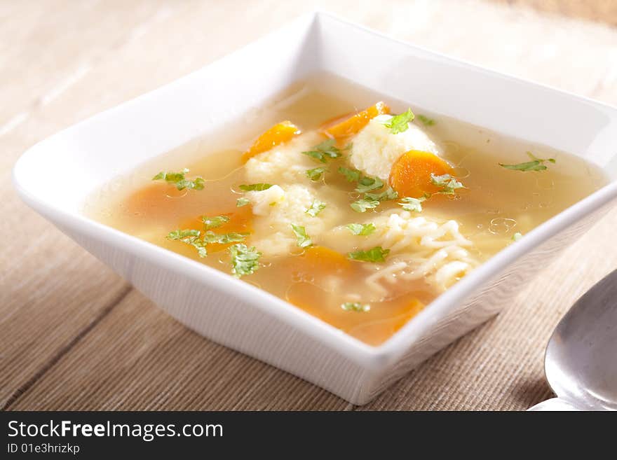 Noodle soup with dumplings and carrots