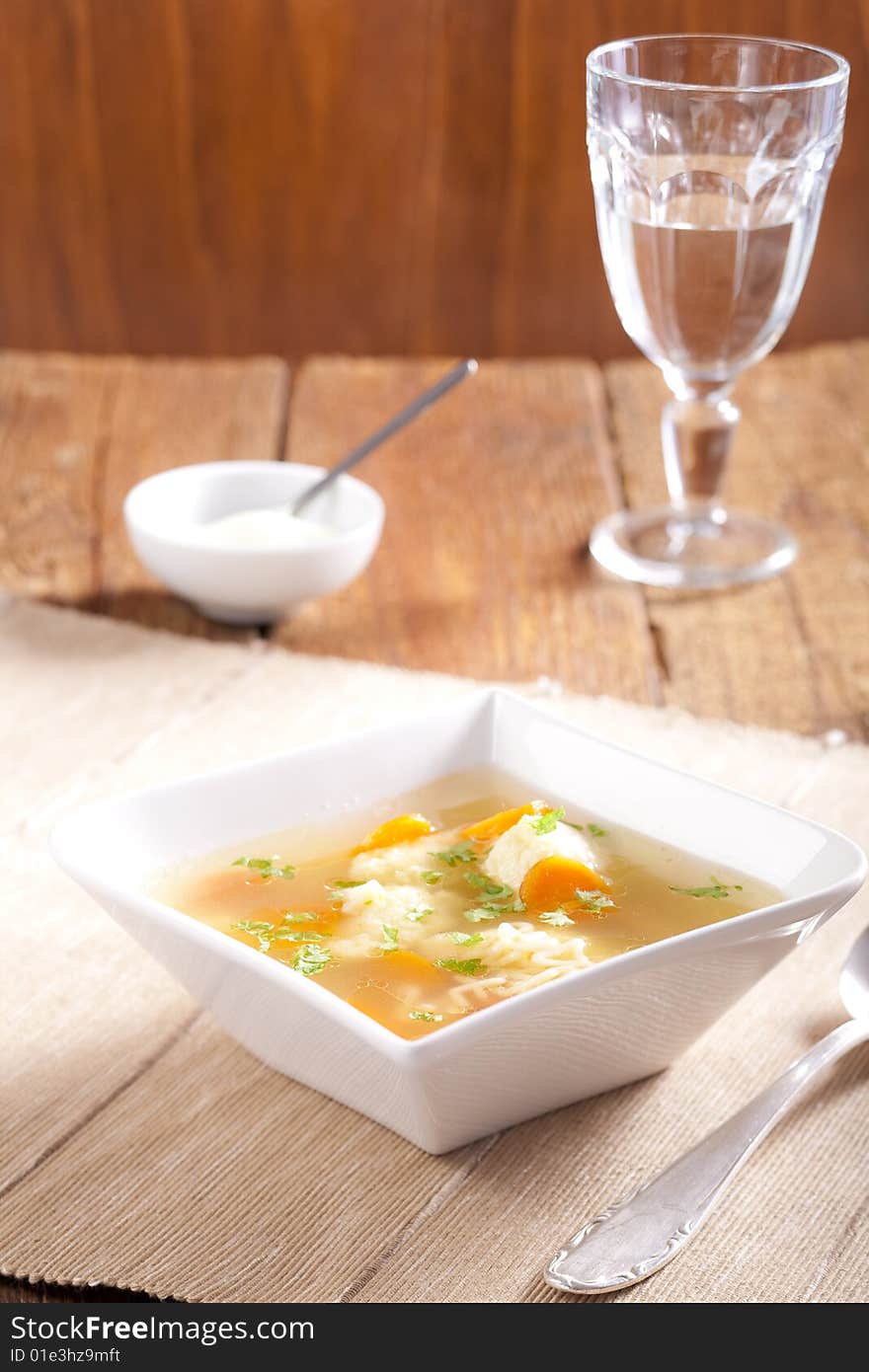 Noodle soup with dumplings and carrots