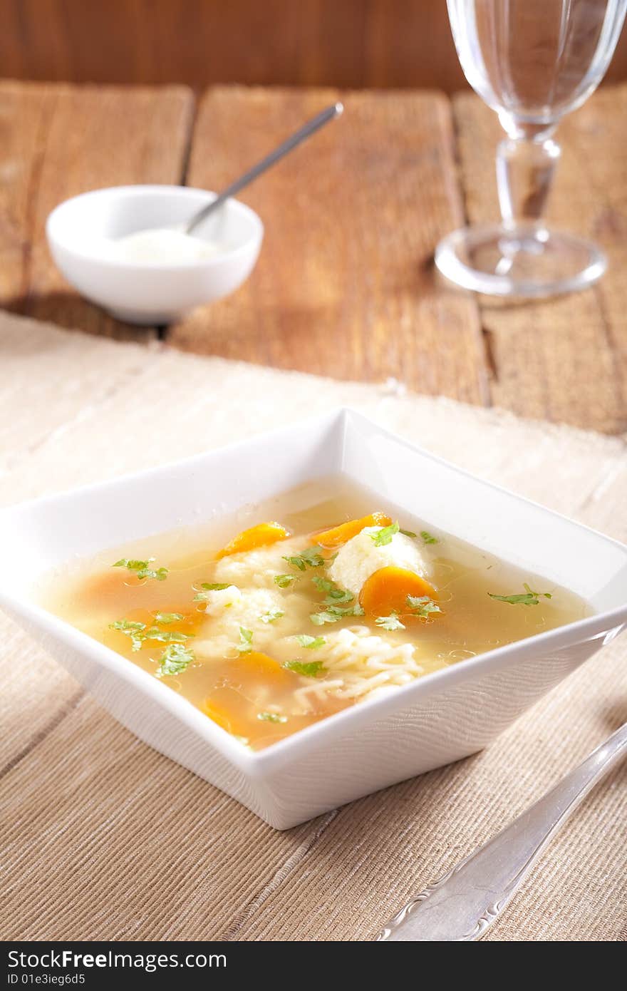 Noodle soup with dumplings and carrots