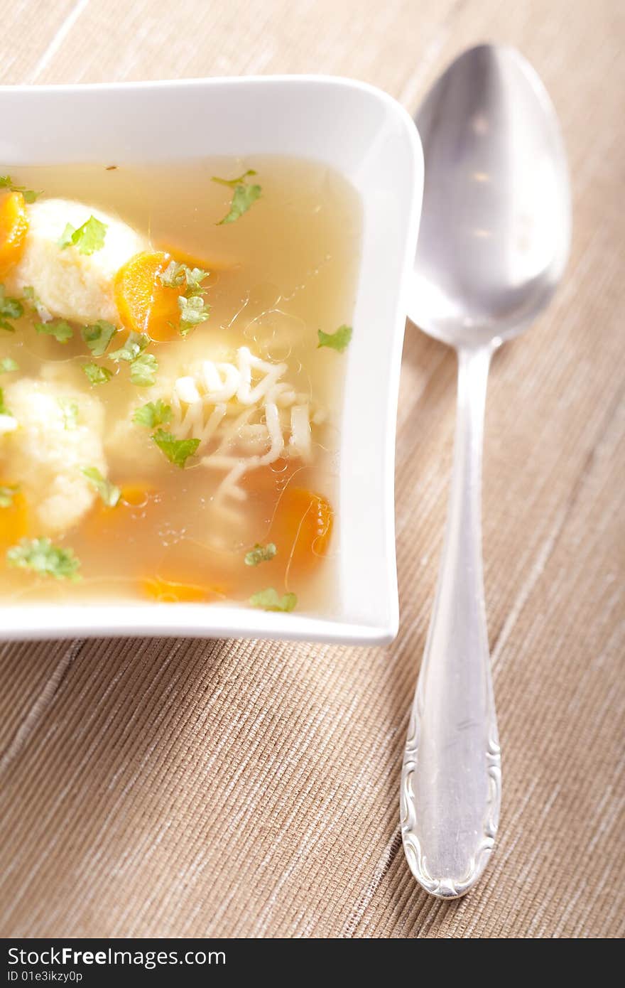 Noodle soup with dumplings and carrots