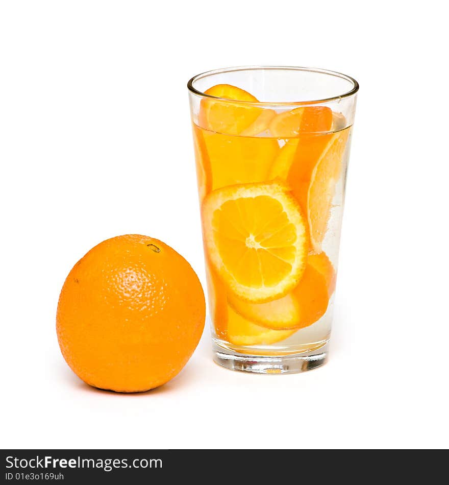 An orange and a glass of orange slices on white backgorund. An orange and a glass of orange slices on white backgorund.