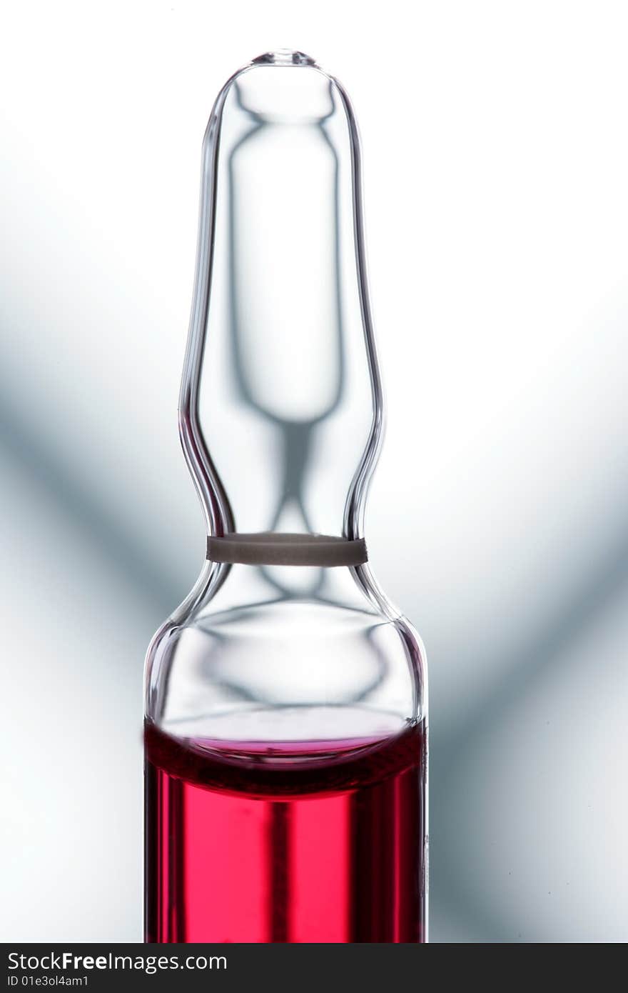 Glass ampoule with red liquid medicine inside