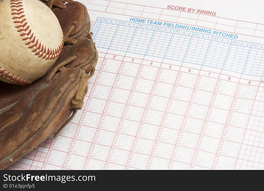 A picture of a ball and glove on a scorebook. A picture of a ball and glove on a scorebook