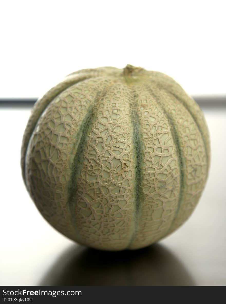 One melon fruit over a stainless steel table