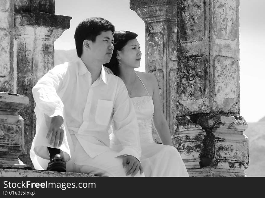 Asian couple sitting together and llooking away. Asian couple sitting together and llooking away