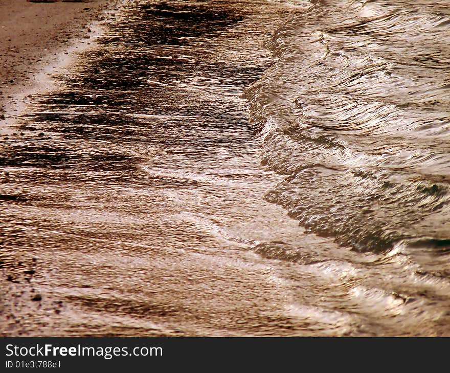 Waves make a lovely pattern on a beach in Bermuda, at sunset. Waves make a lovely pattern on a beach in Bermuda, at sunset.